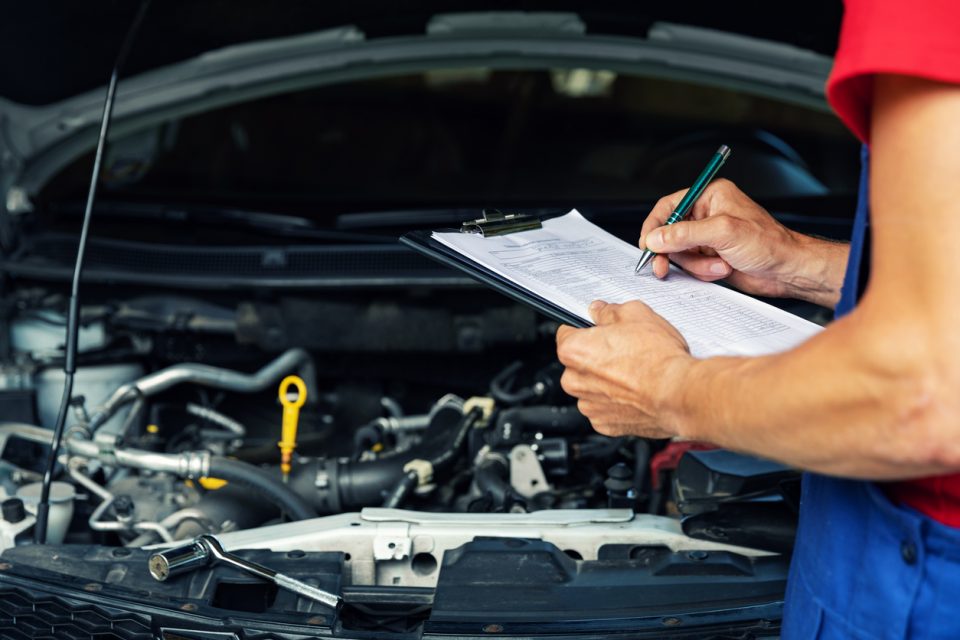 Mechanic performing a service on a vehicle