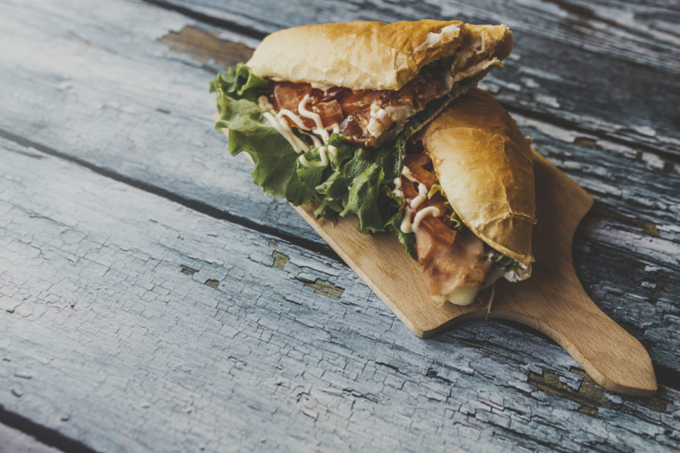 Delicious sandwich on cutting board.