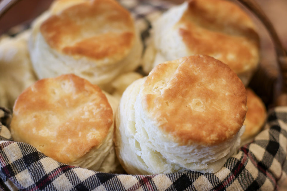 Selective focus closeup of a basket of fresh homemade buttermilk biscuits