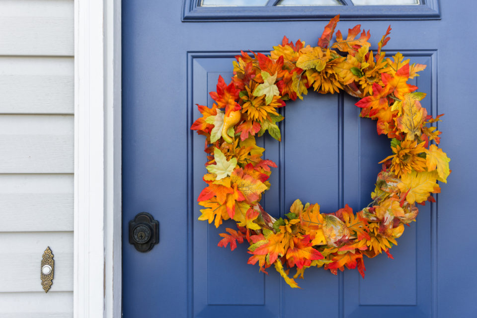 Closeup of front door and decorative autumn wreath