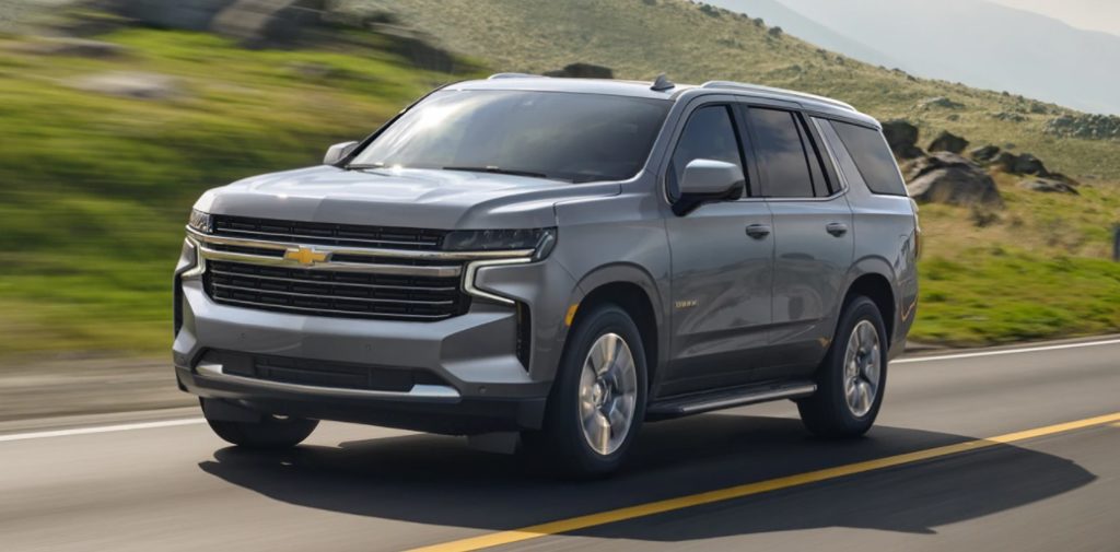 Chevy Tahoe on the road with a background of motion-blurred hills