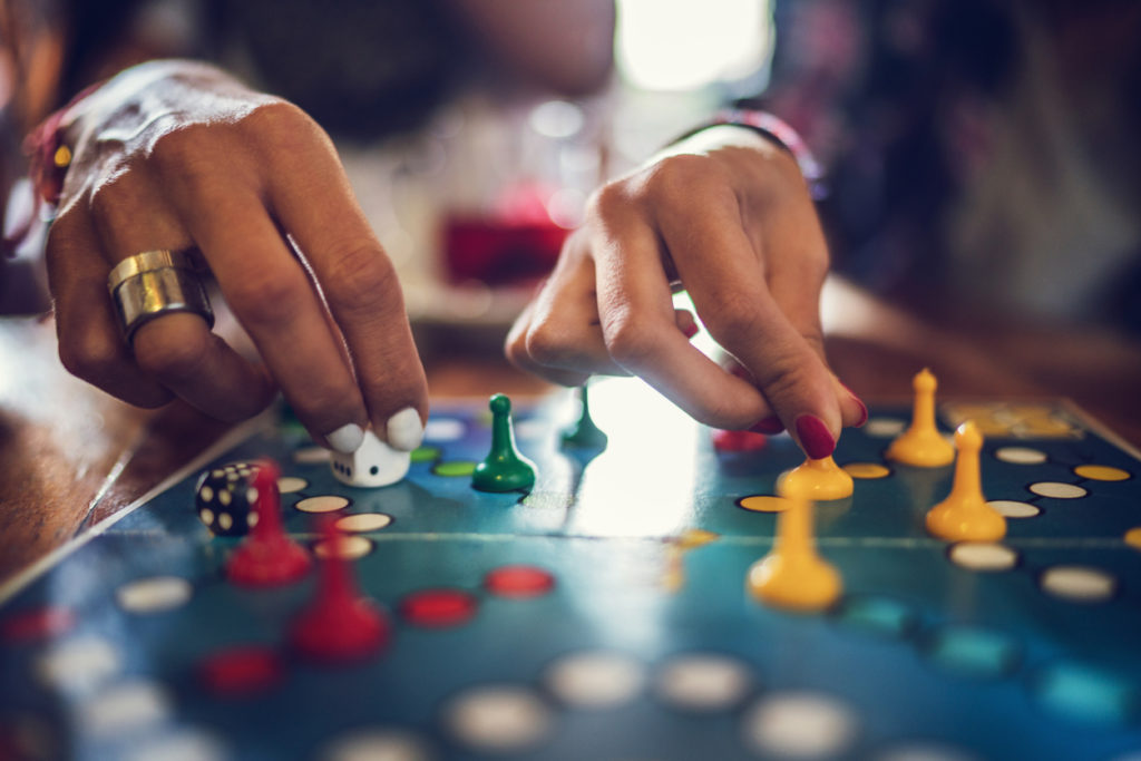 Close up of unrecognizable women playing board game.