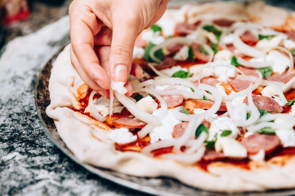 Man preparing pizza to bake