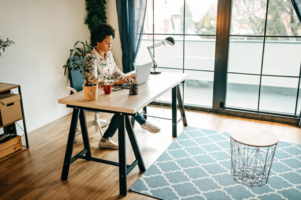 Young business woman working from home office.