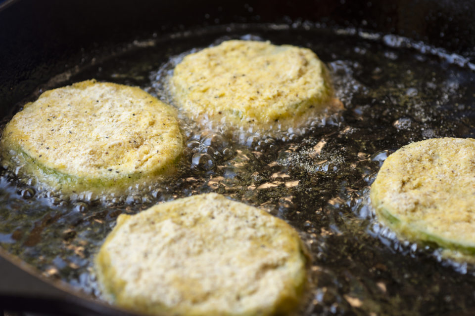 Fried Green Tomatoes Cooking in a Cast Iron Skillet