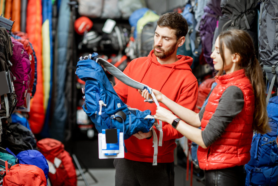 Couple looking on the sports equipment in the shop