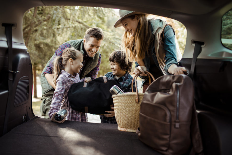 Close up of a young family packing up for a road trip