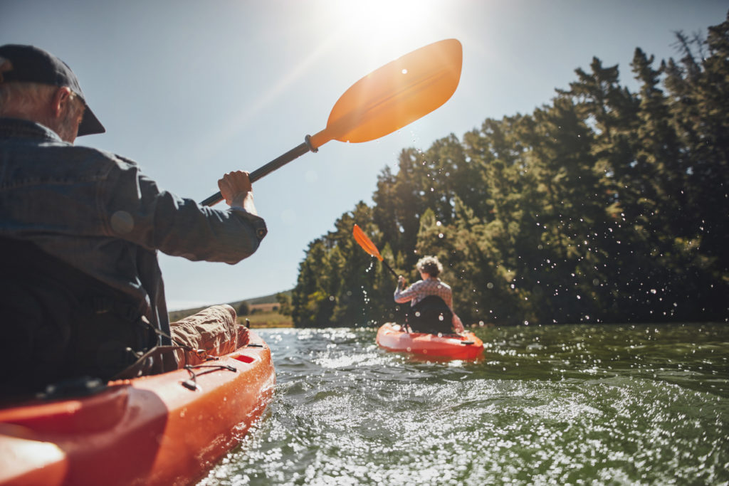 Senior couple kayaking in a lake