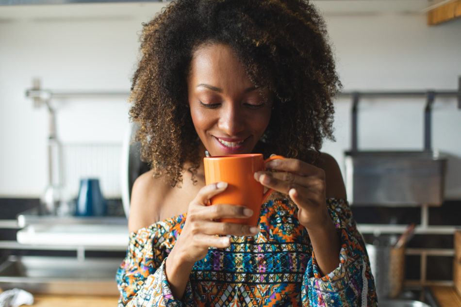 Woman drinking coffee in her home