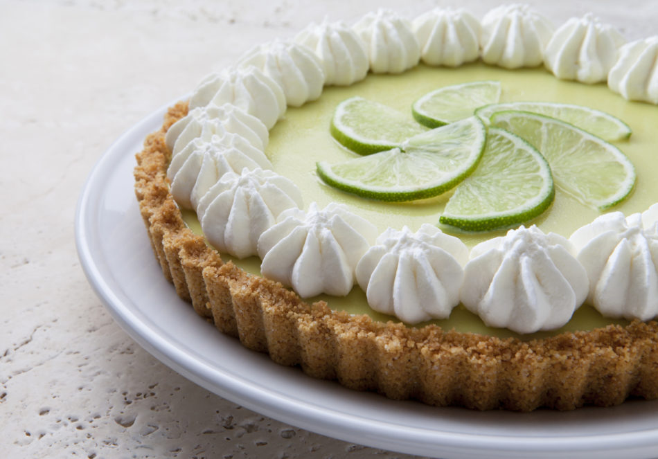 ey Lime Pie With Whipped Cream on a Marble Tabletop.