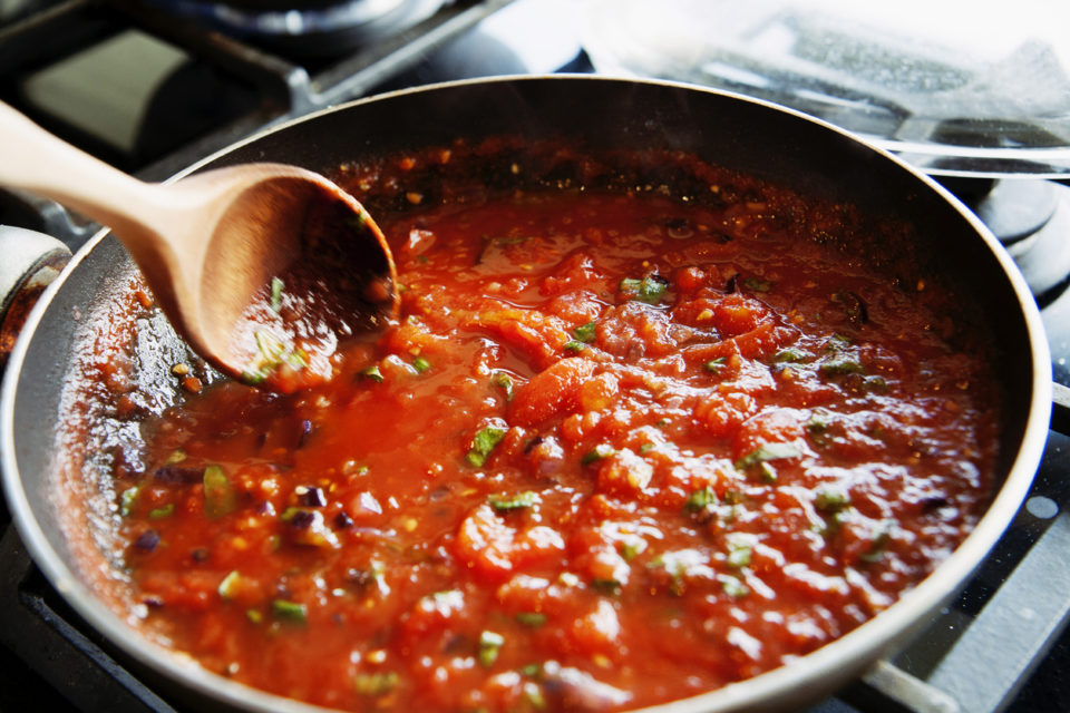 Preparing fresh tomato sauce in a domestic kitchen.