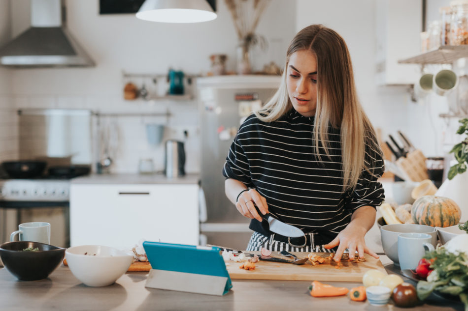 female watching a recipe and cooking in the kitchen