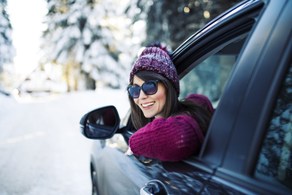 woman traveling by car during winter snow