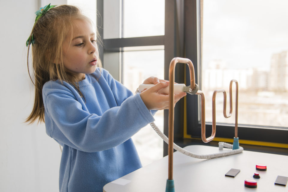 The little girl exploring electricity at museum