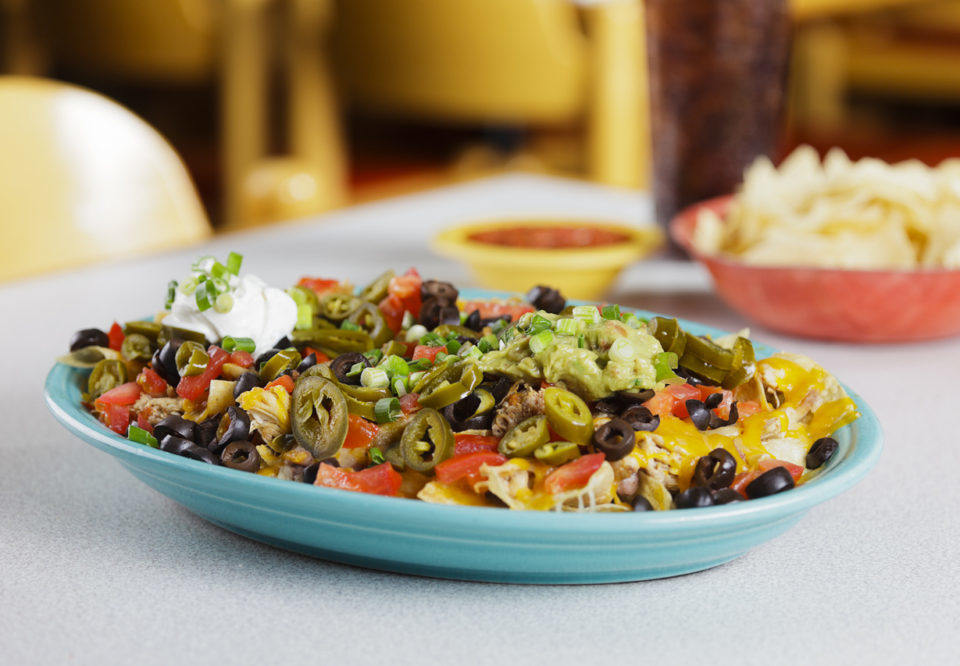 A plate of nachos in a Mexican restaurant.