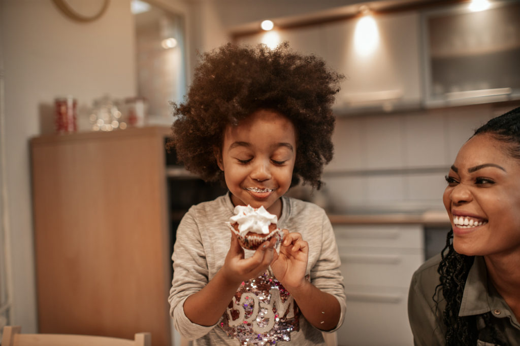 little girl enjoying a cupcake
