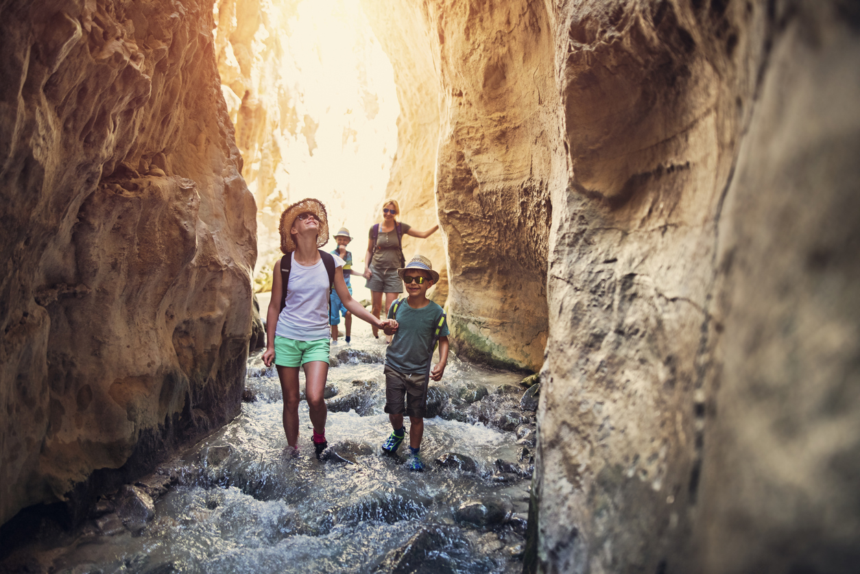 family hiking through cavern 