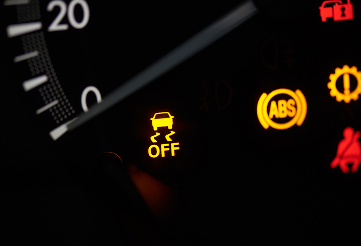 Close up of car speedometer  with yellow warning sign