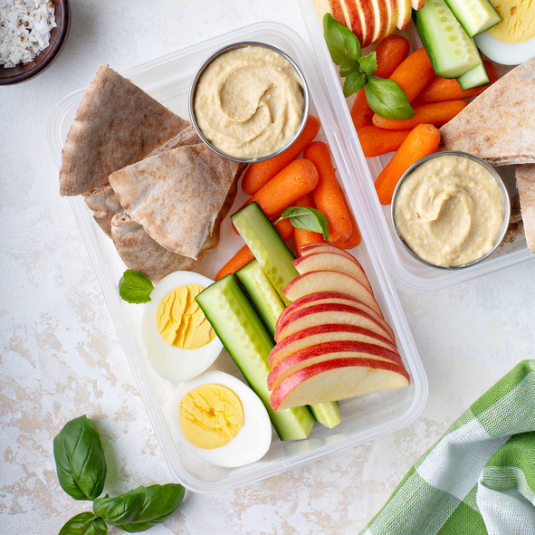 Healthy and nutritious lunch or snack boxes to go with hummus and pita, eggs and vegetables