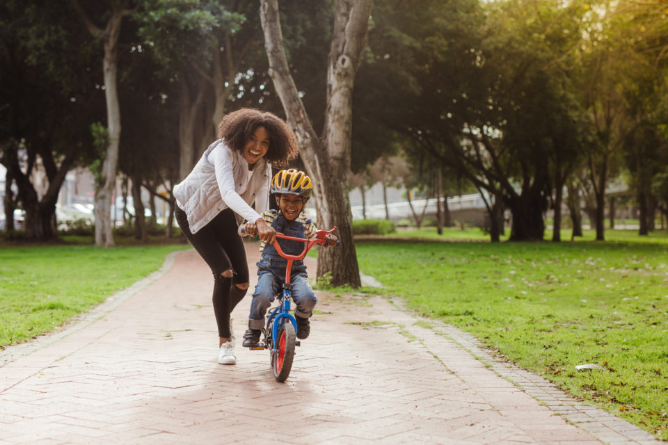 Child learning to ride a bike hotsell