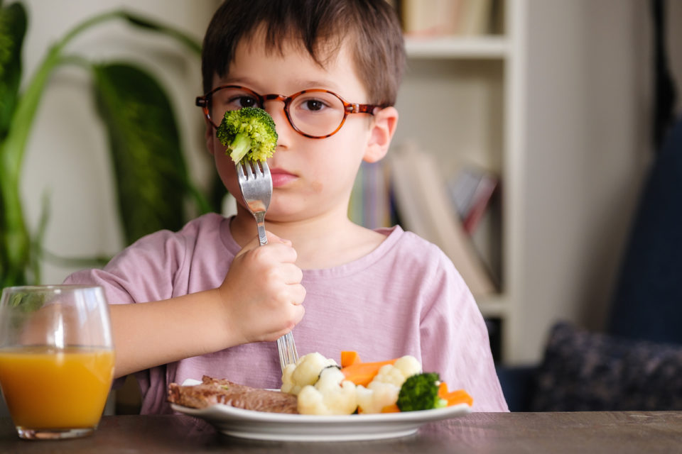 Child is very unhappy with having to eat vegetables. There is a lot of vegetables on his plate. He hates vegetables.