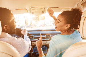 Couple listening to music while driving a car